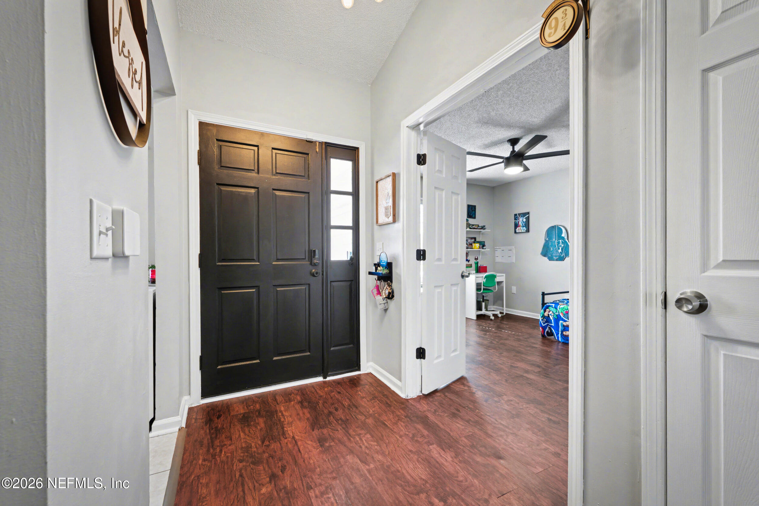 2992 Quapaw Trail Middleburg, FL 32068 - Photo 3 of 32 a bedroom with a bed and a chandelier