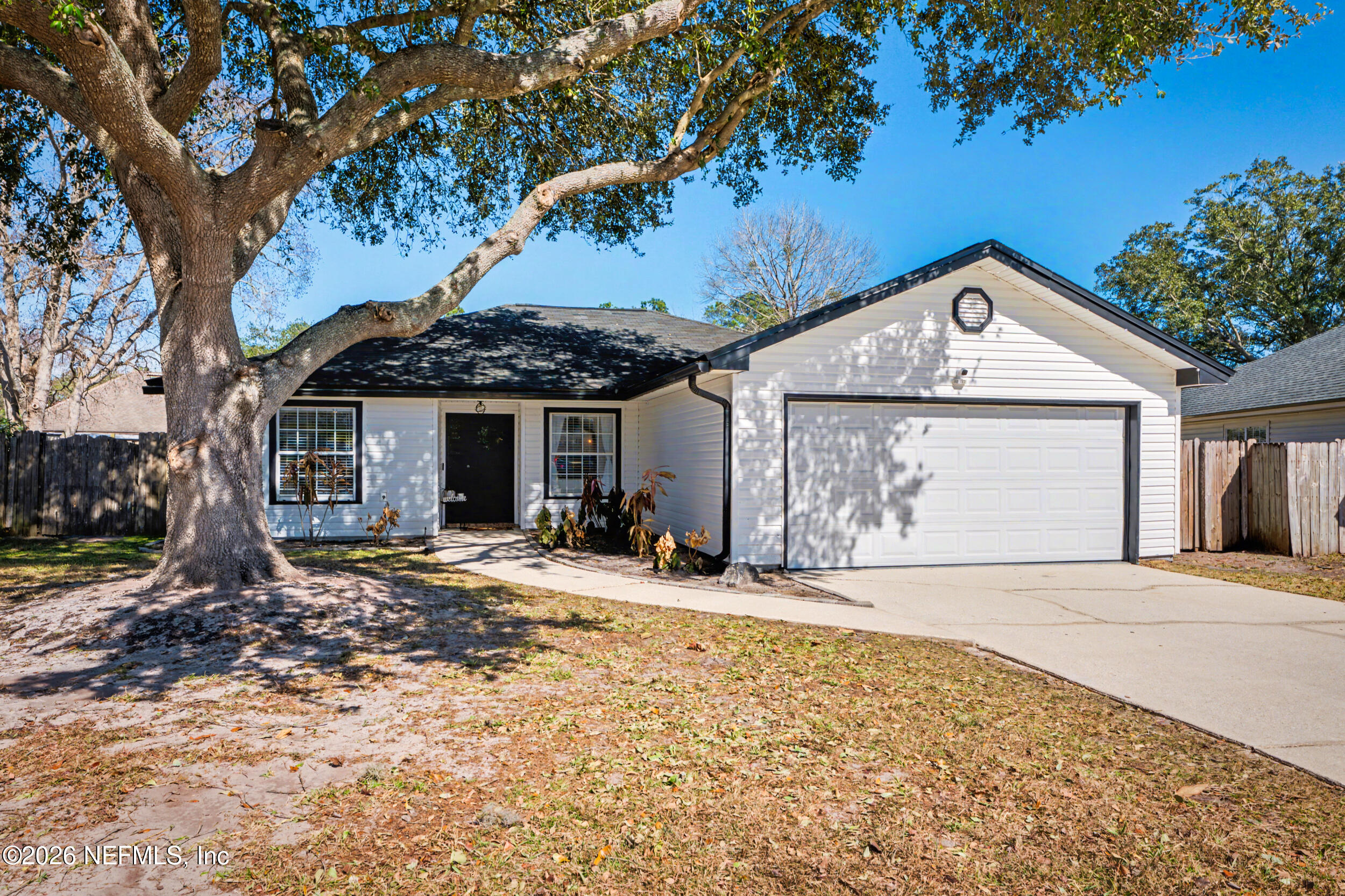 2992 Quapaw Trail Middleburg, FL 32068 - Photo 32 of 32 a front view of a house with a garden and patio