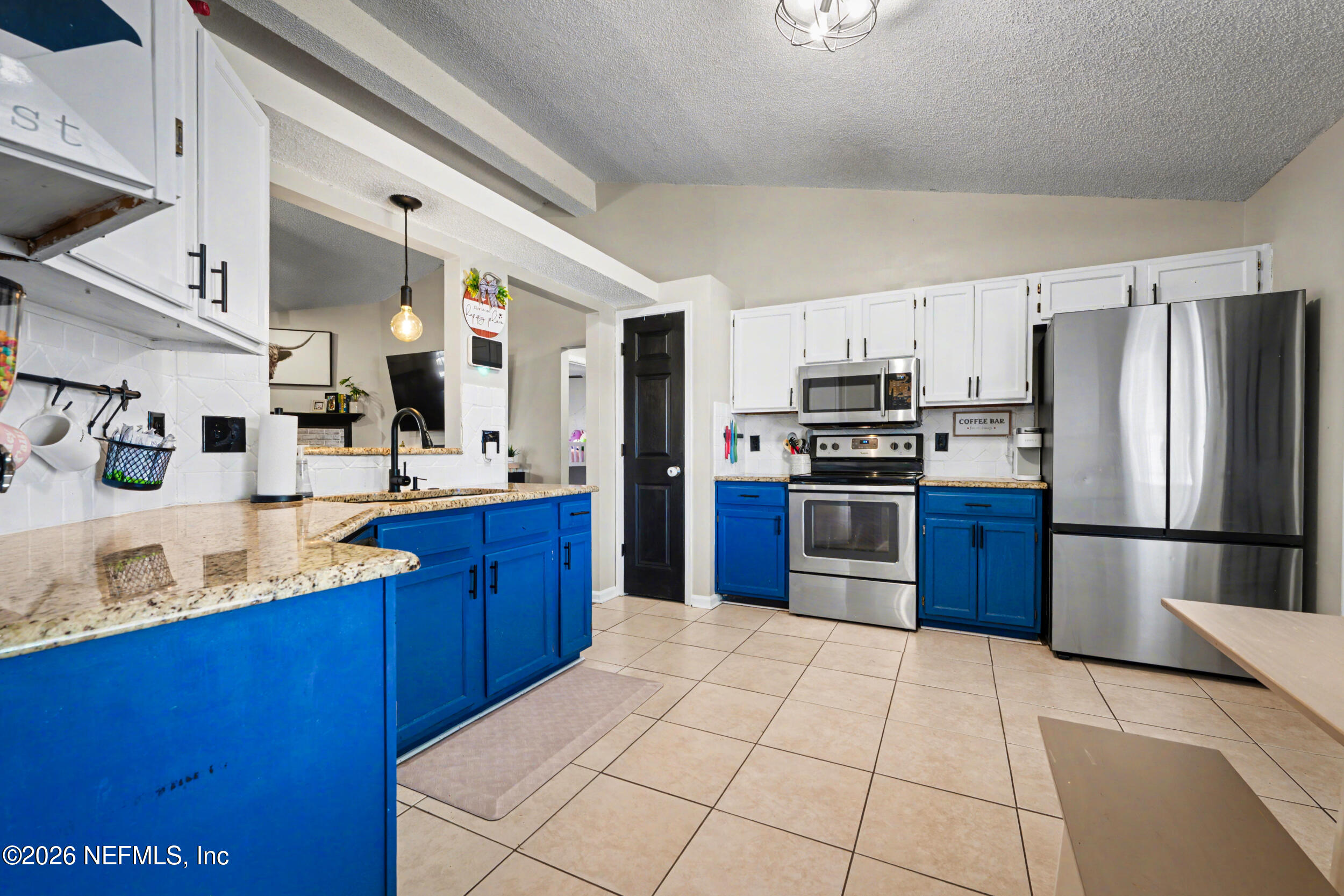 2992 Quapaw Trail Middleburg, FL 32068 - Photo 4 of 32 a kitchen with stainless steel appliances granite countertop a refrigerator and a stove