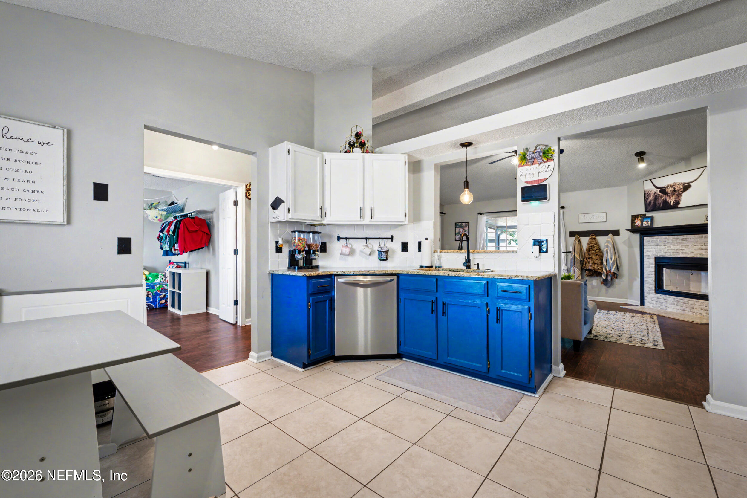 2992 Quapaw Trail Middleburg, FL 32068 - Photo 5 of 32 a kitchen with stainless steel appliances kitchen island granite countertop a refrigerator and stove