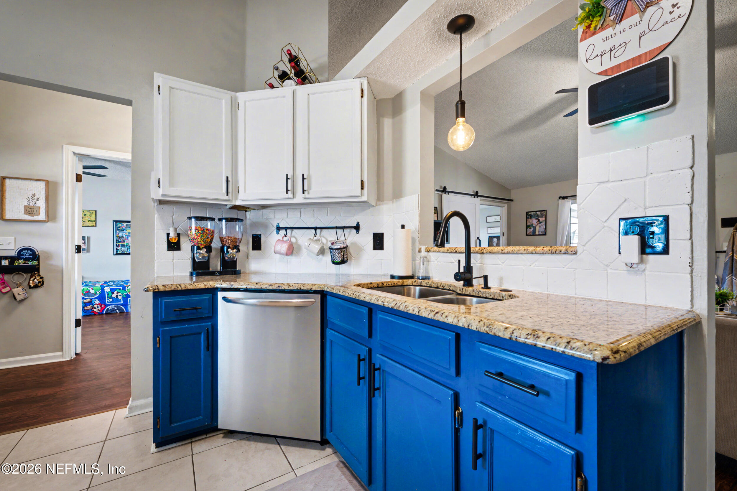 2992 Quapaw Trail Middleburg, FL 32068 - Photo 6 of 32 a kitchen with stainless steel appliances granite countertop a sink dishwasher stove and cabinets with wooden floor