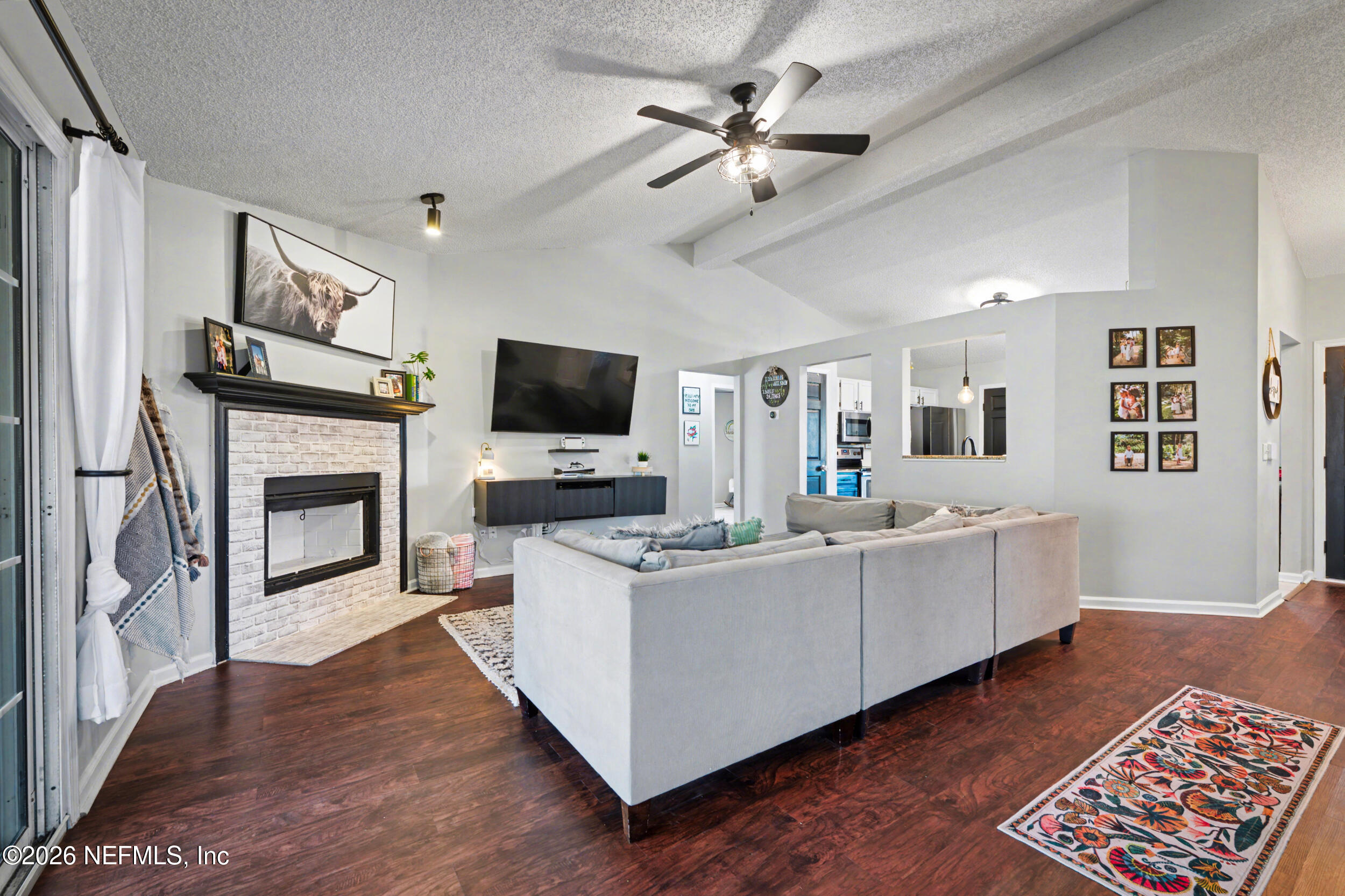 2992 Quapaw Trail Middleburg, FL 32068 - Photo 9 of 32 a living room with furniture a flat screen tv and a fireplace