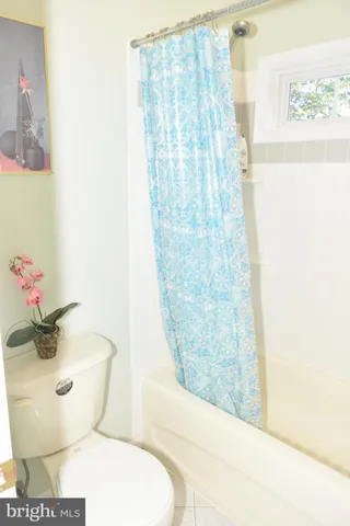 an empty room with a fan and a window