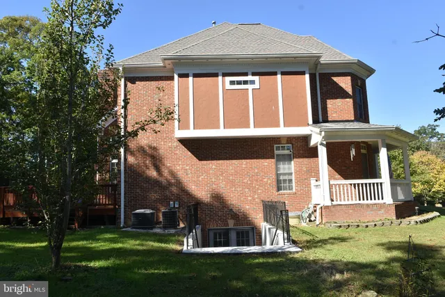 a view of deck with furniture and trees