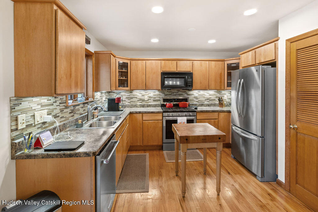 10 Old Farm Road Shokan, NY 12481 - Photo 5 of 68 a kitchen with kitchen island a stove a refrigerator and a refrigerator with wooden floor