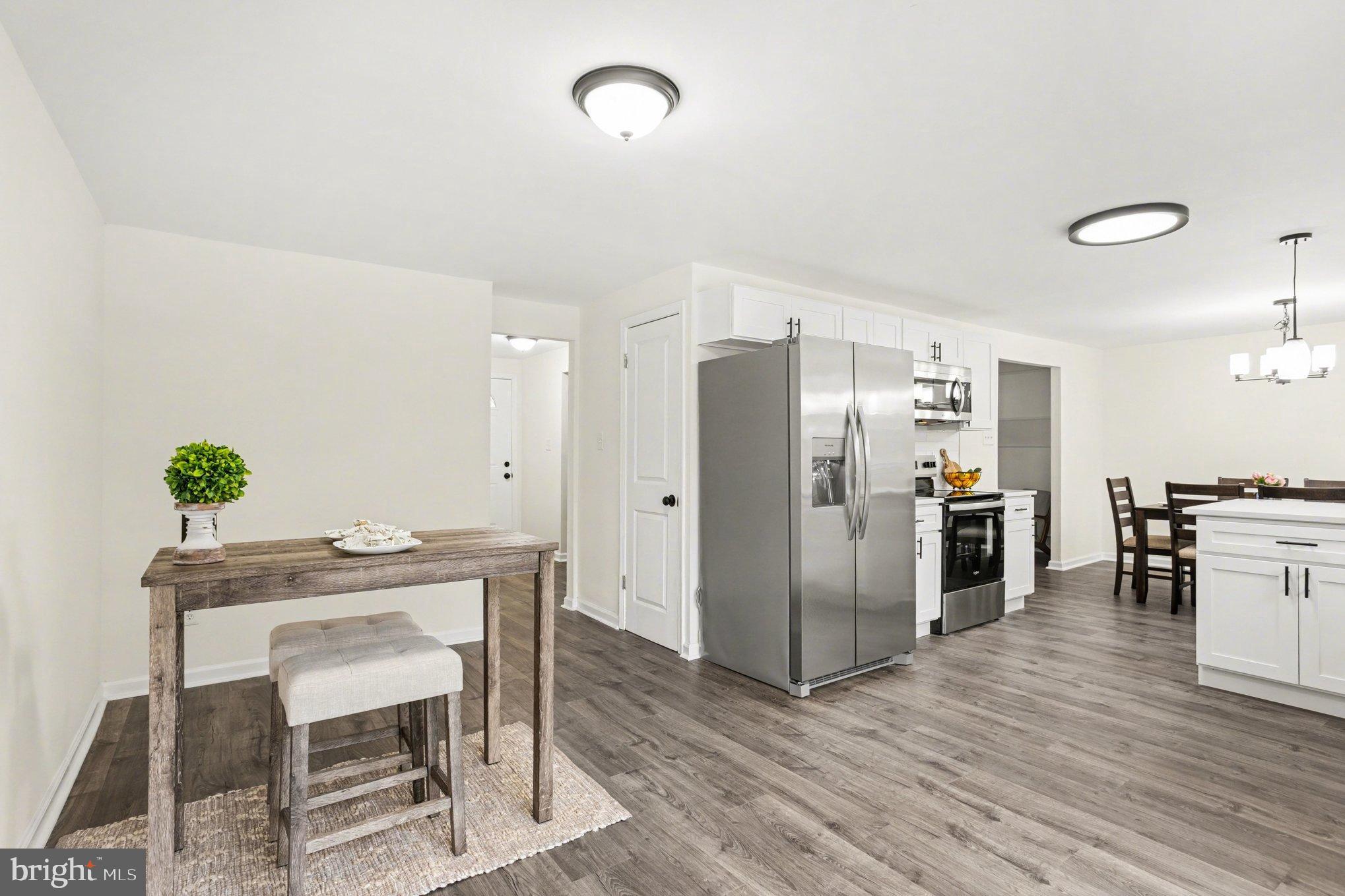 8029 Rider Avenue Towson, MD 21204 - Photo 12 of 41 a kitchen with stainless steel appliances a refrigerator and a dining table