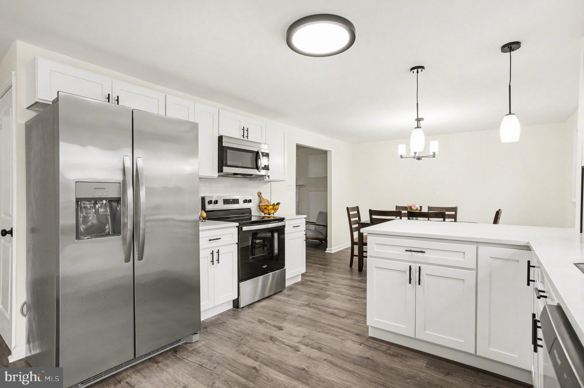 8029 Rider Avenue Towson, MD 21204 - Photo 13 of 41 a kitchen with cabinets stainless steel appliances and wooden floor