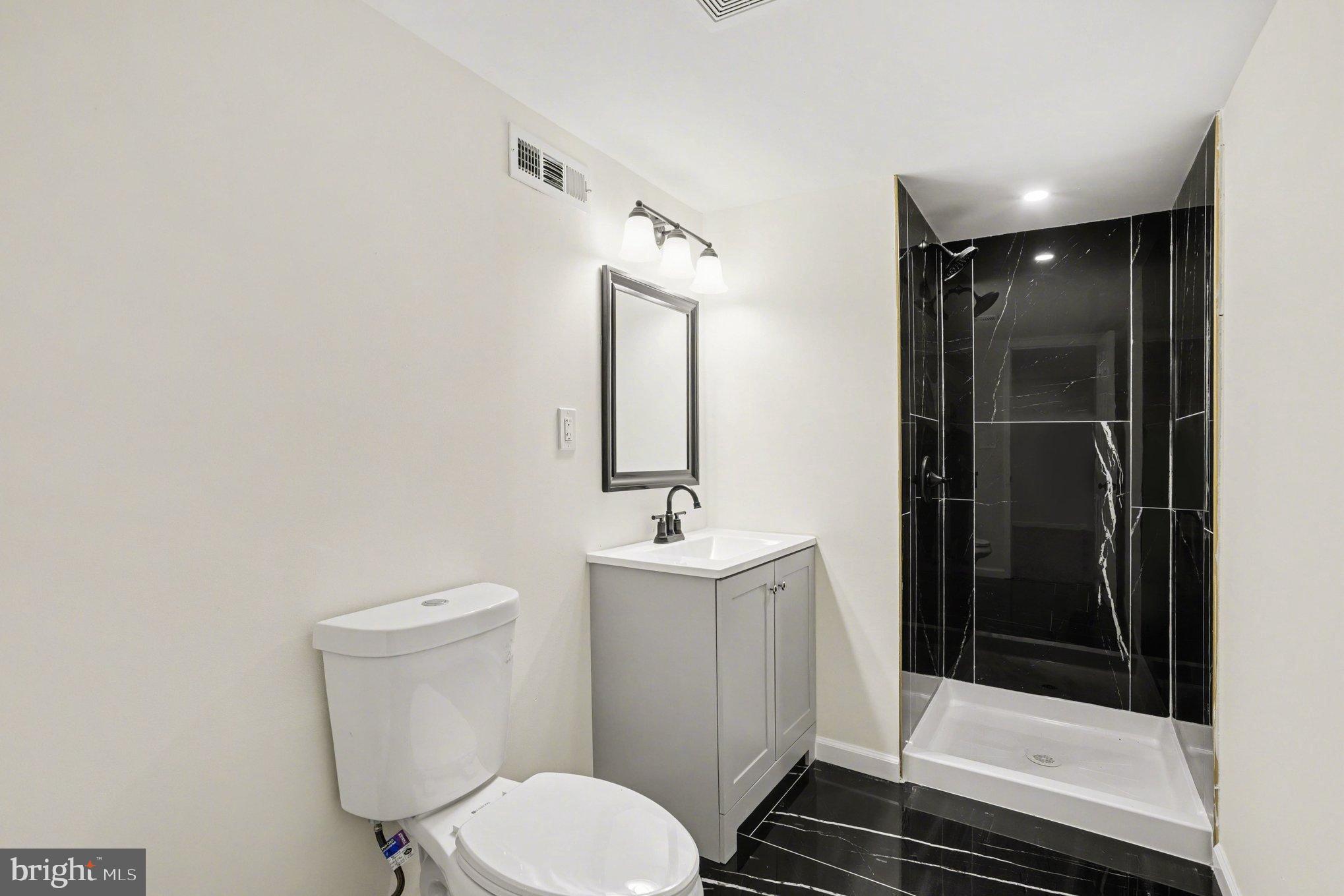 8029 Rider Avenue Towson, MD 21204 - Photo 30 of 41 a bathroom with a toilet a sink and shower