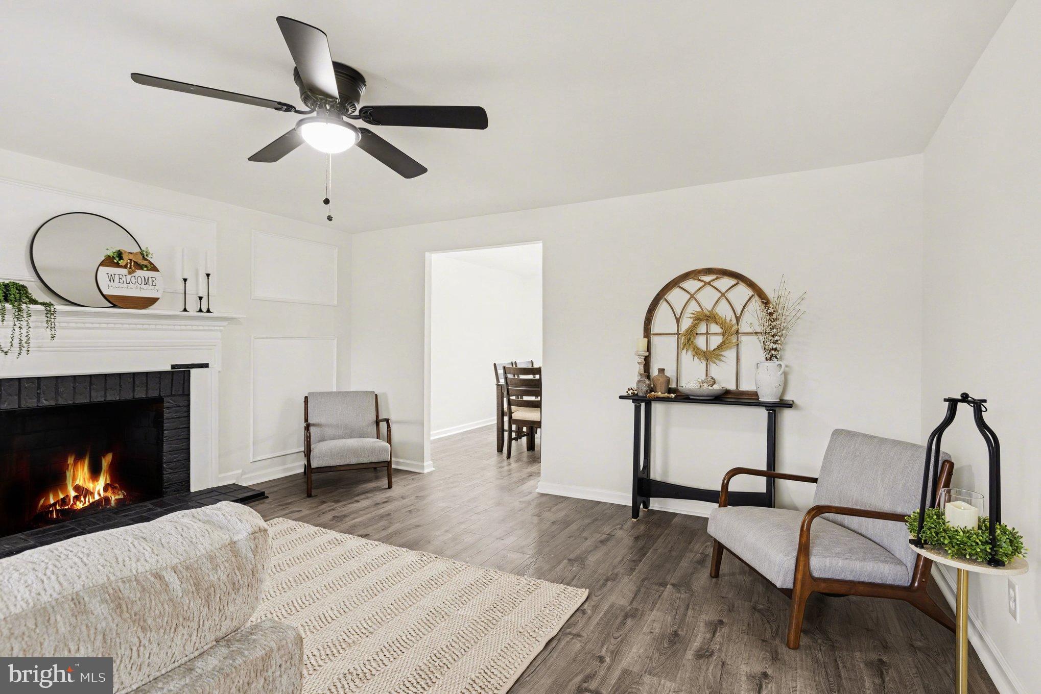 8029 Rider Avenue Towson, MD 21204 - Photo 9 of 41 a living room with furniture a window and a fireplace