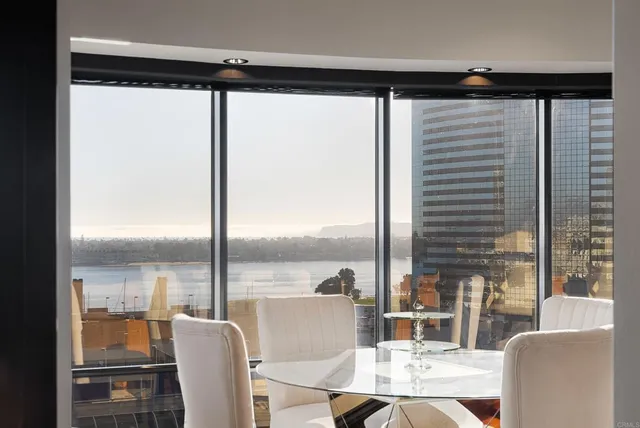 a living room with large windows and furniture