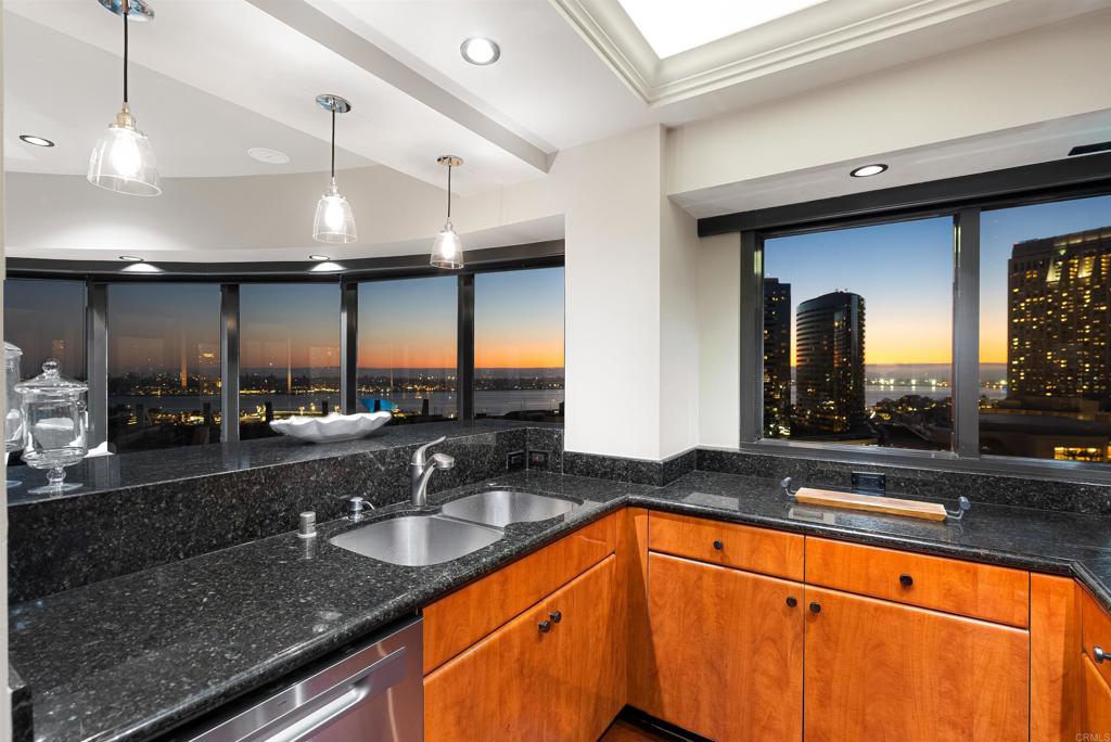 200 Harbor Drive, Unit 1502 San Diego, CA 92101 - Photo 43 of 48 a kitchen with granite countertop a sink and a large window