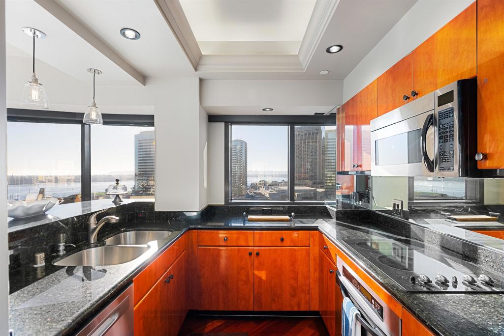 200 Harbor Drive, Unit 1502 San Diego, CA 92101 - Photo 7 of 48 a kitchen with large windows and sink
