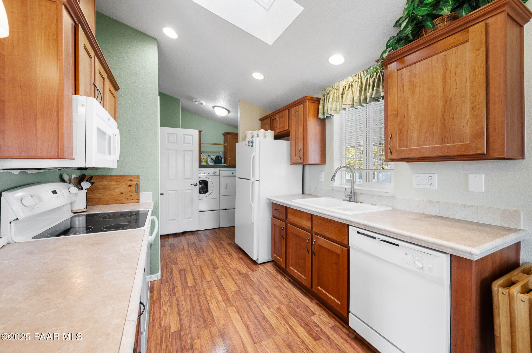 2214 Dove Drive Dewey, AZ 86327 - Photo 14 of 27 a kitchen with stainless steel appliances granite countertop a sink and wooden cabinets with a large window