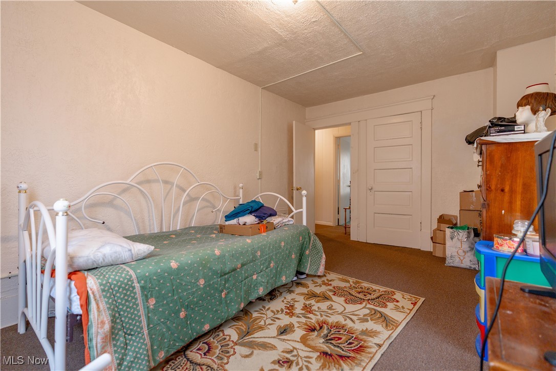 900 4th Street Southwest Canton, OH 44707 - Photo 15 of 31 Carpeted bedroom featuring a textured ceiling