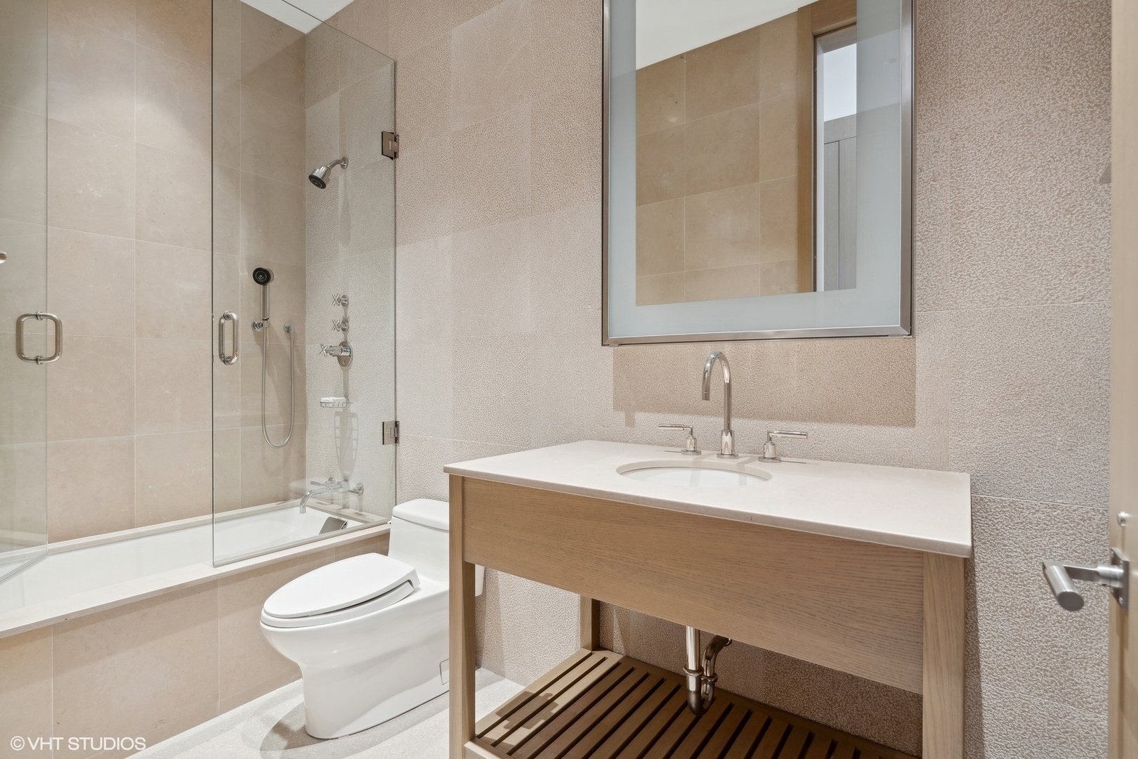 55 East Erie Street, Unit 5201 Chicago, IL 60611 - Photo 14 of 23 a bathroom with a sink toilet vanity and shower