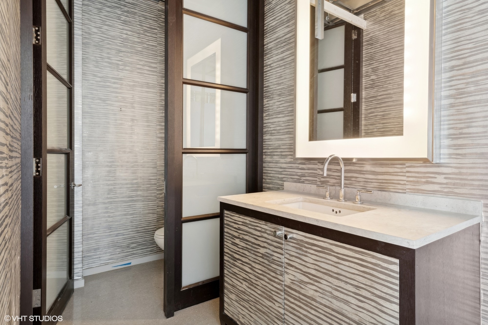 55 East Erie Street, Unit 5201 Chicago, IL 60611 - Photo 15 of 23 a bathroom with a sink and a mirror