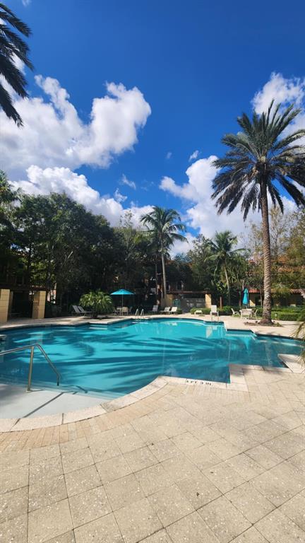 6884 West Sample Road, Unit 6884 Coral Springs, FL 33067 - Photo 12 of 14 a view of a park and trees in the background