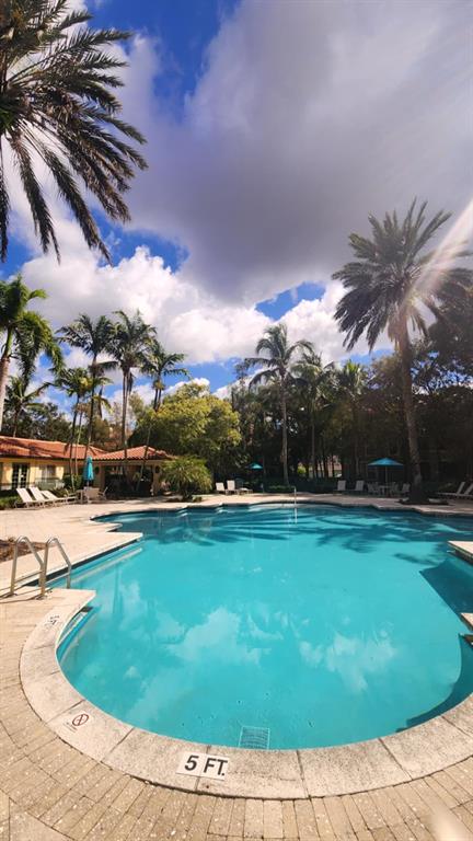 6884 West Sample Road, Unit 6884 Coral Springs, FL 33067 - Photo 13 of 14 a view of a swimming pool and lake view