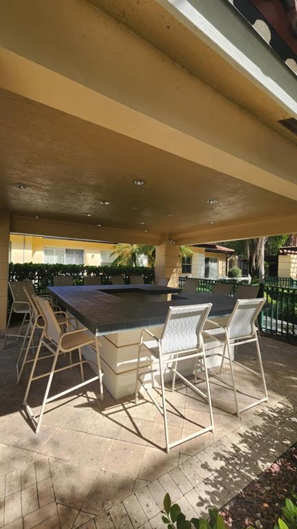 6884 West Sample Road, Unit 6884 Coral Springs, FL 33067 - Photo 14 of 14 a view of a chairs and table on the terrace