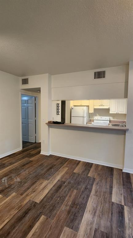 6884 West Sample Road, Unit 6884 Coral Springs, FL 33067 - Photo 3 of 14 a kitchen with granite countertop a stove and cabinets