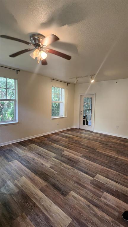 6884 West Sample Road, Unit 6884 Coral Springs, FL 33067 - Photo 4 of 14 a view of empty room with wooden floor and fan