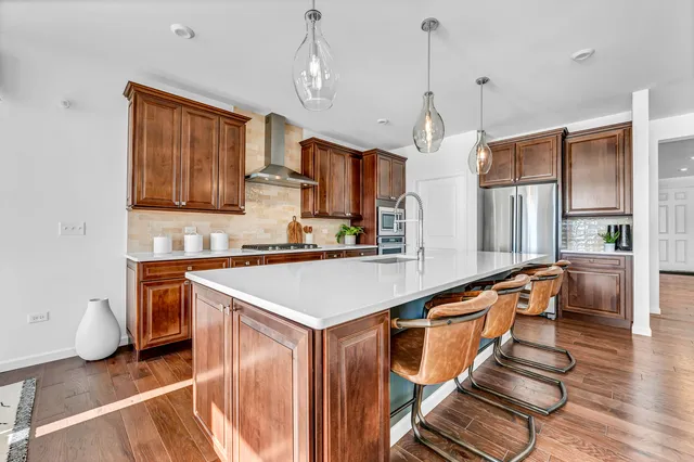 a kitchen with wooden cabinets and refrigerator