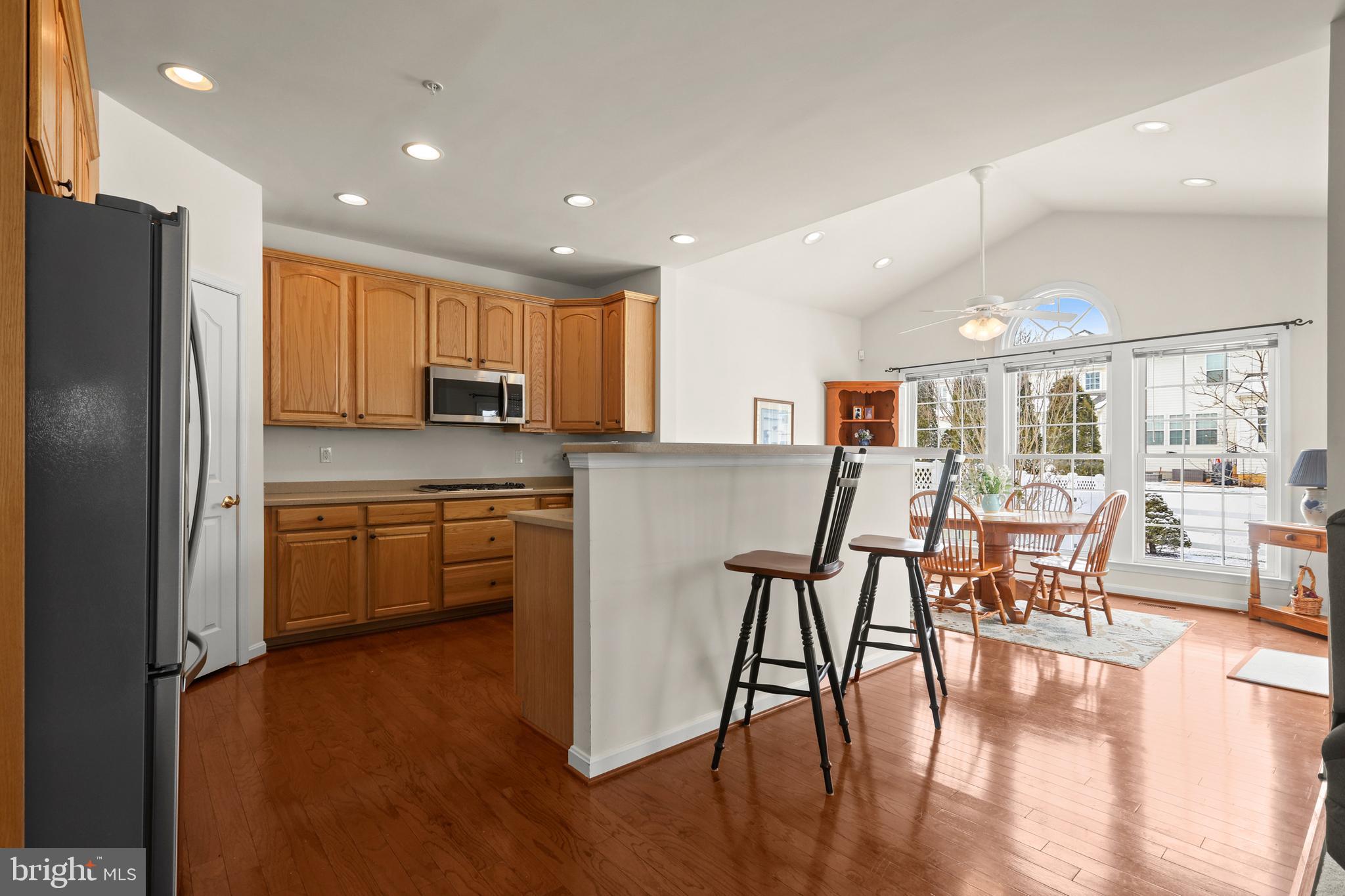 804 Bridle Path Bel Air, MD 21014 - Photo 16 of 53 a kitchen with stainless steel appliances granite countertop a table chairs refrigerator and sink