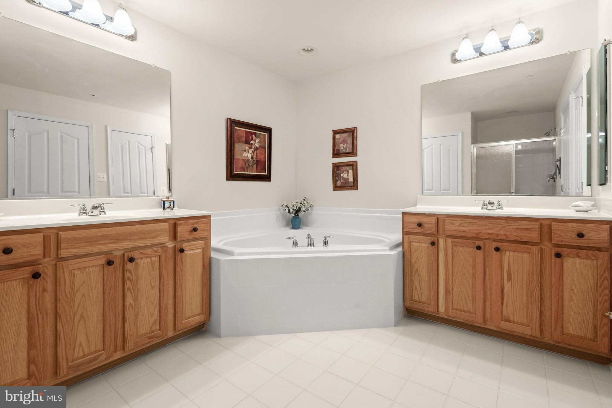 804 Bridle Path Bel Air, MD 21014 - Photo 37 of 53 a spacious bathroom with a double vanity sink mirror and bathtub