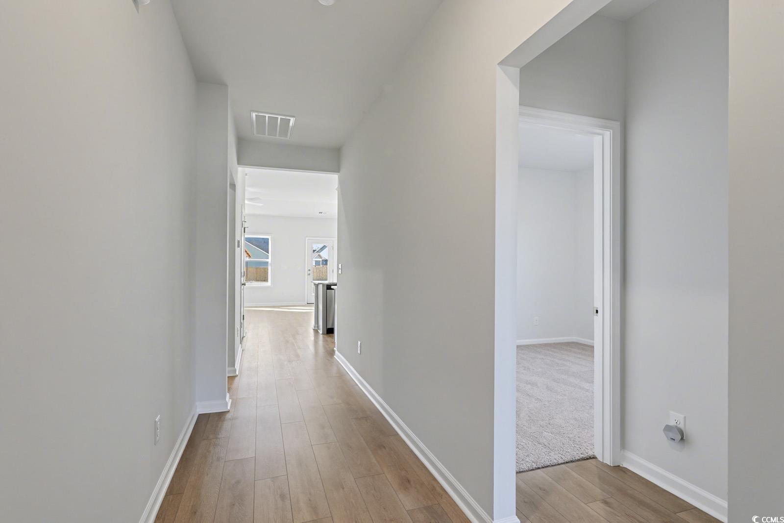 235 Sundrop Way Conway, SC 29526 - Photo 16 of 24 Hallway with baseboards and light wood-style flooring