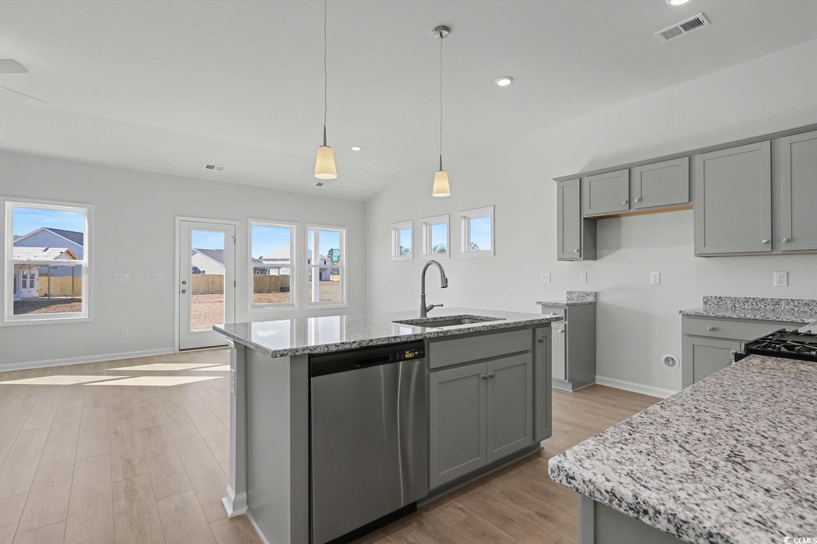 235 Sundrop Way Conway, SC 29526 - Photo 6 of 24 Kitchen featuring gray cabinetry, light stone counters, stainless steel dishwasher, an island with sink, and recessed lighting