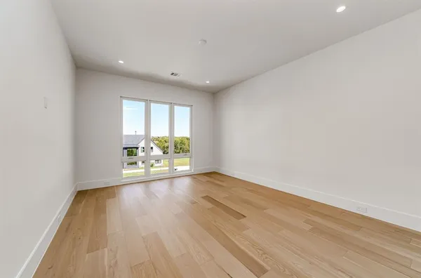 a spacious bathroom with a sink a toilet a mirror and bathtub