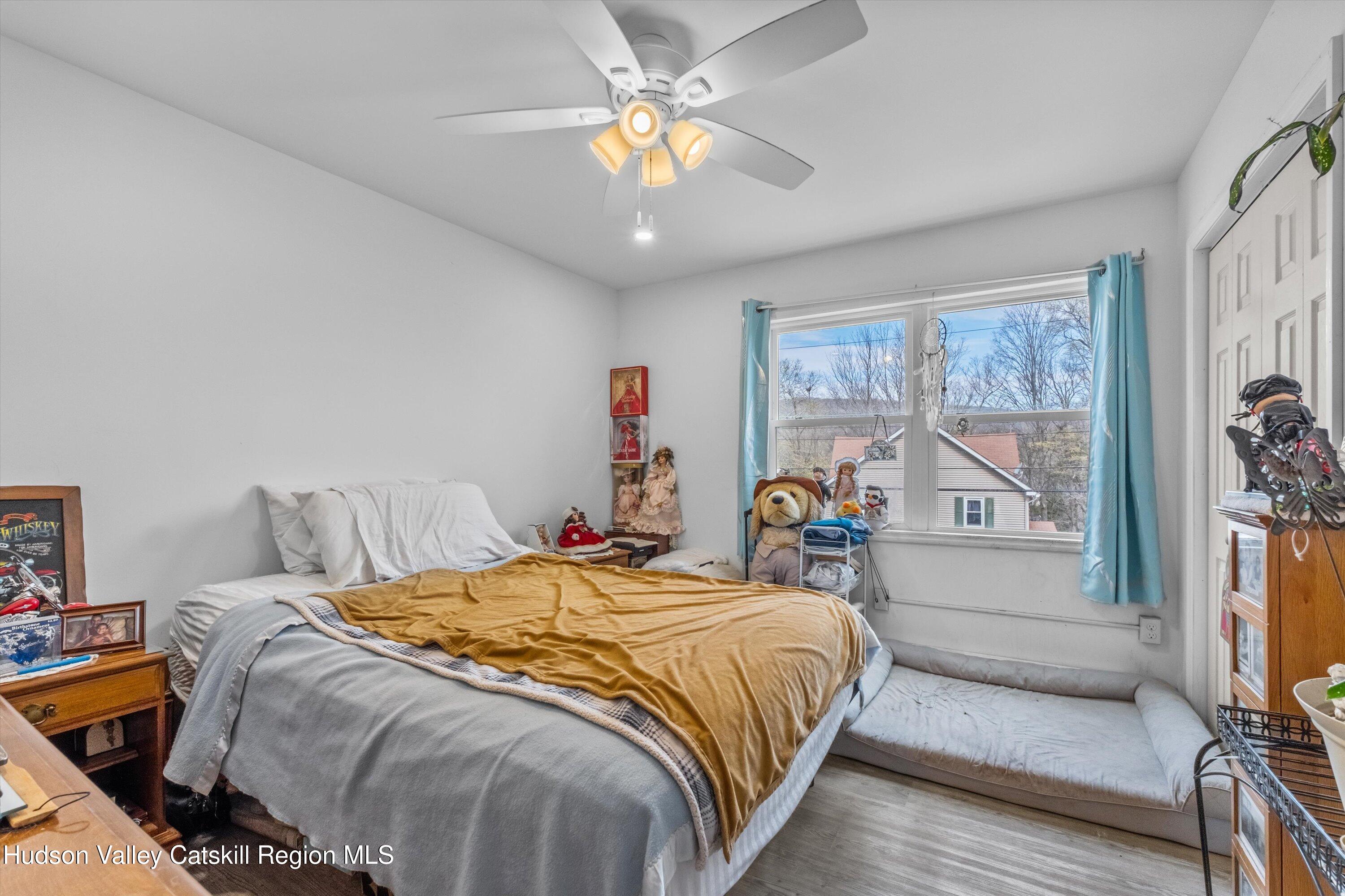 6 Smith Terrace Lloyd, NY 12528 - Photo 22 of 33 a bedroom with a bed and a chandelier