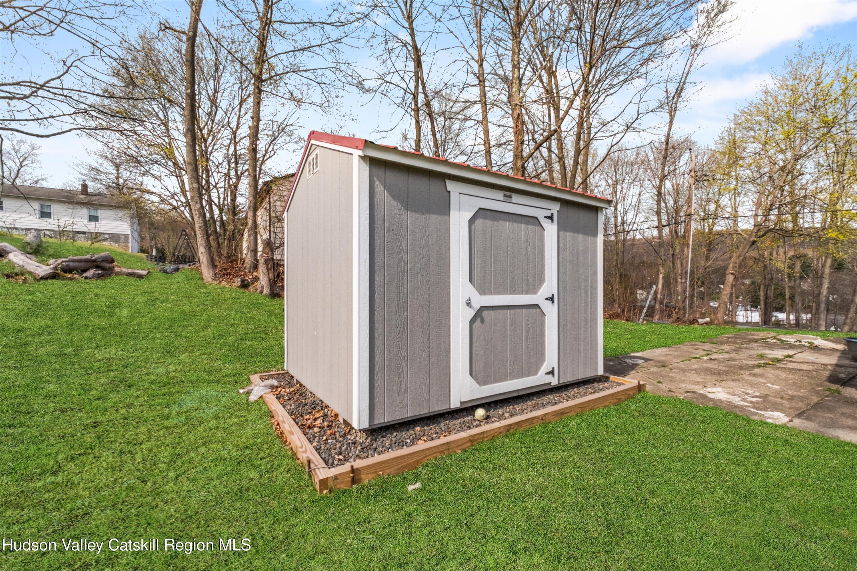 6 Smith Terrace Lloyd, NY 12528 - Photo 32 of 33 a backyard of a house with large trees and barbeque oven