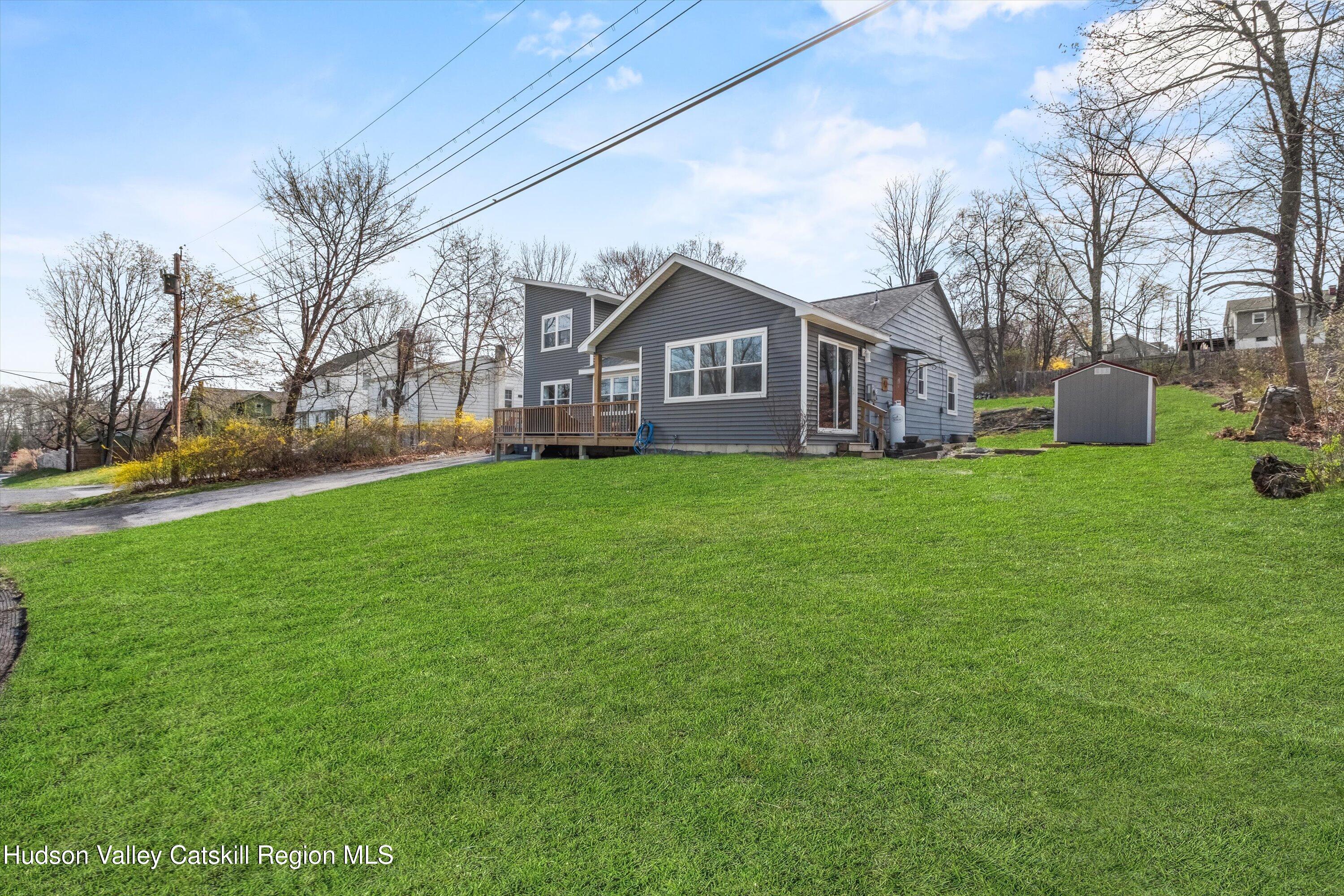 6 Smith Terrace Lloyd, NY 12528 - Photo 5 of 33 a house that is sitting in the grass with large trees and plants
