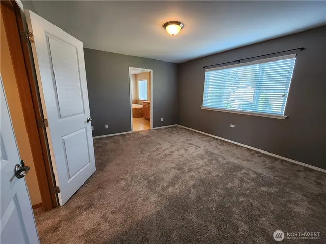 an empty room with windows and closet