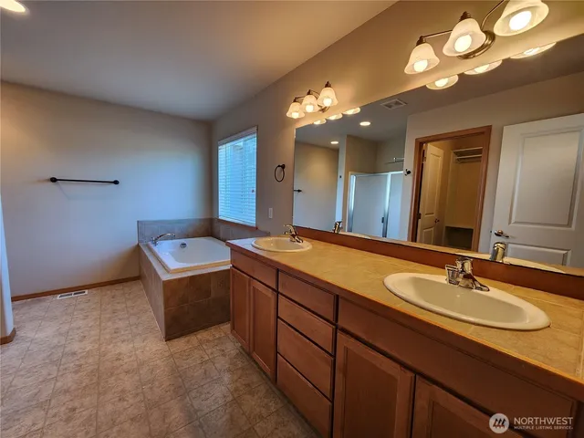 a bathroom with a sink double vanity and a mirror