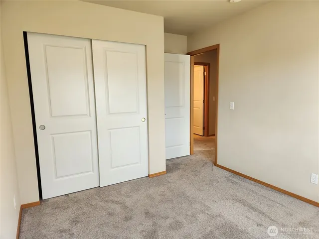 a view of an empty room and closet area