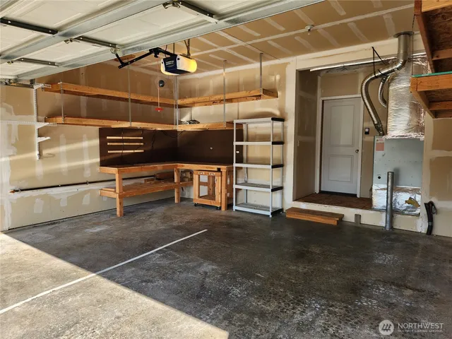 a view of a backyard with a small deck and wooden fence