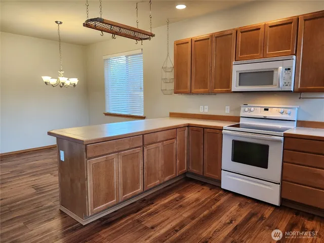 a kitchen with a sink cabinets and wooden floor