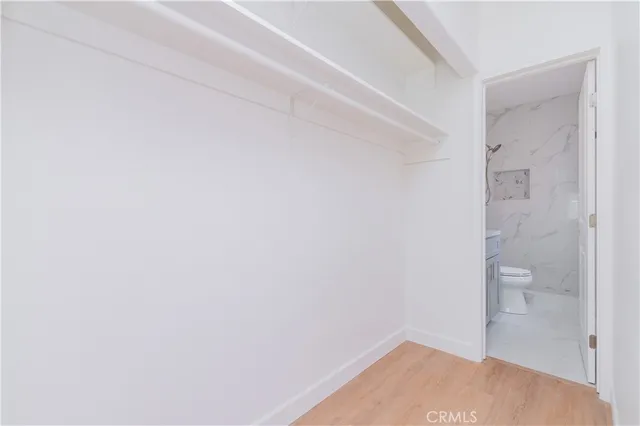 a bathroom with a sink toilet a mirror and shower