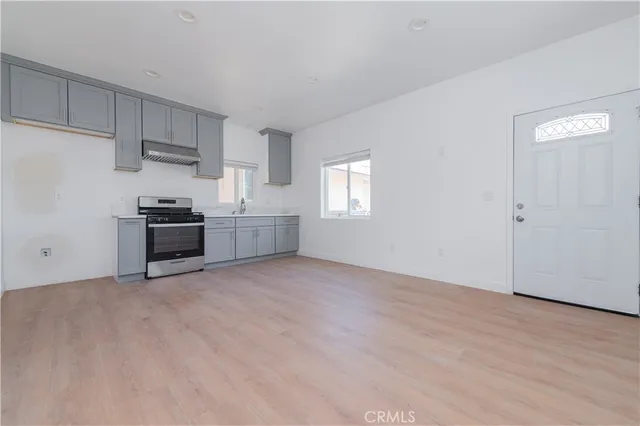 a view of a kitchen with a sink dishwasher and a refrigerator