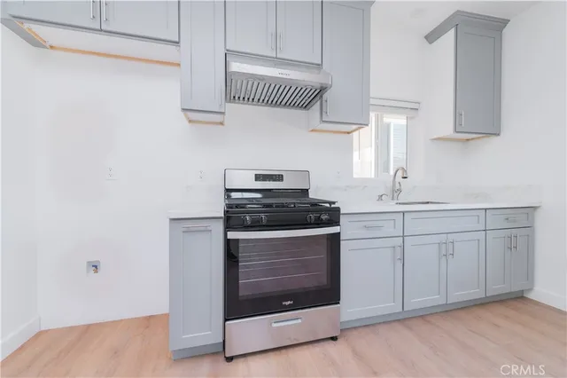 a kitchen with white cabinets and appliances