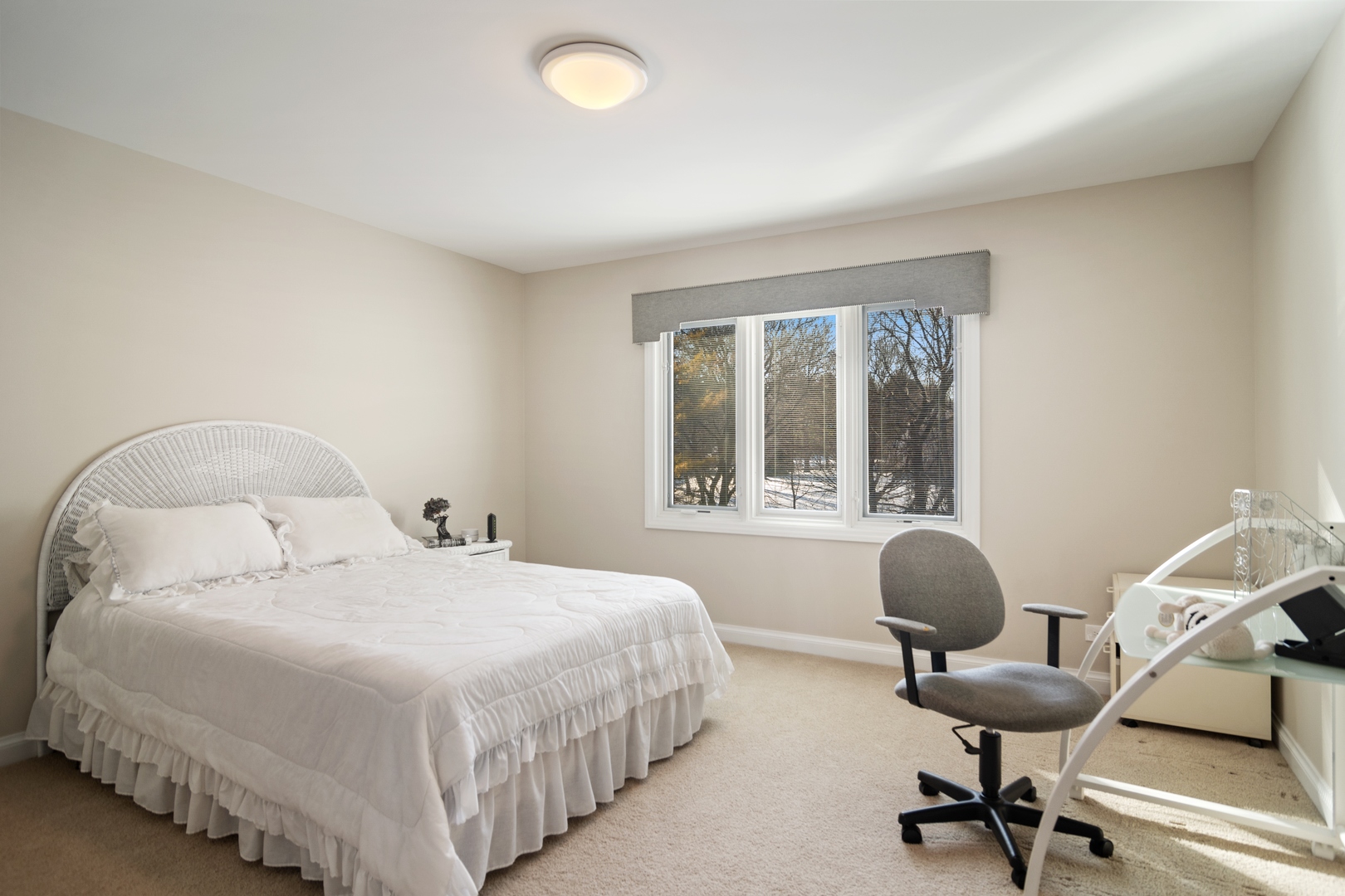 6238 Pine Tree Drive Long Grove, IL 60047 - Photo 20 of 28 a spacious bedroom with a bed a table and a large window