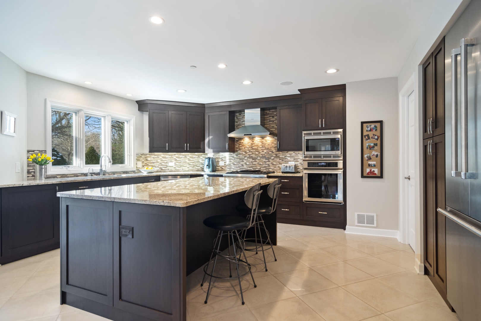 6238 Pine Tree Drive Long Grove, IL 60047 - Photo 4 of 28 a kitchen with stainless steel appliances kitchen island granite countertop a refrigerator and cabinets