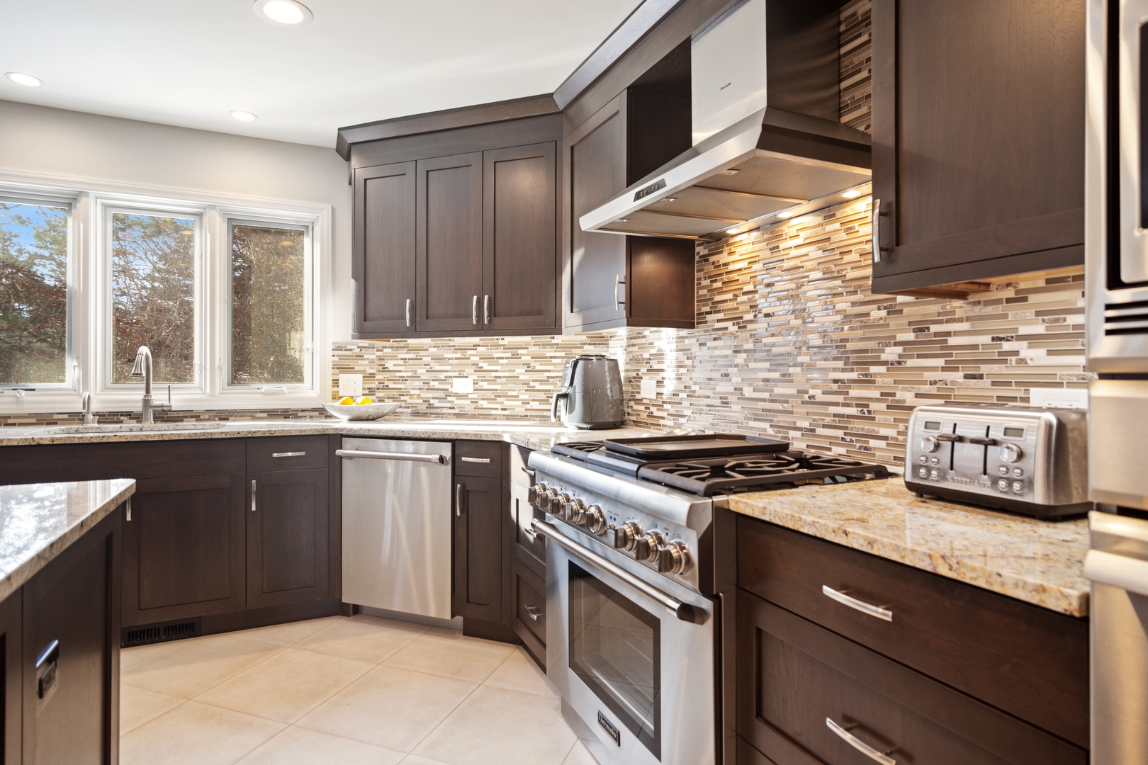 6238 Pine Tree Drive Long Grove, IL 60047 - Photo 5 of 28 a kitchen with stainless steel appliances granite countertop a stove and a sink
