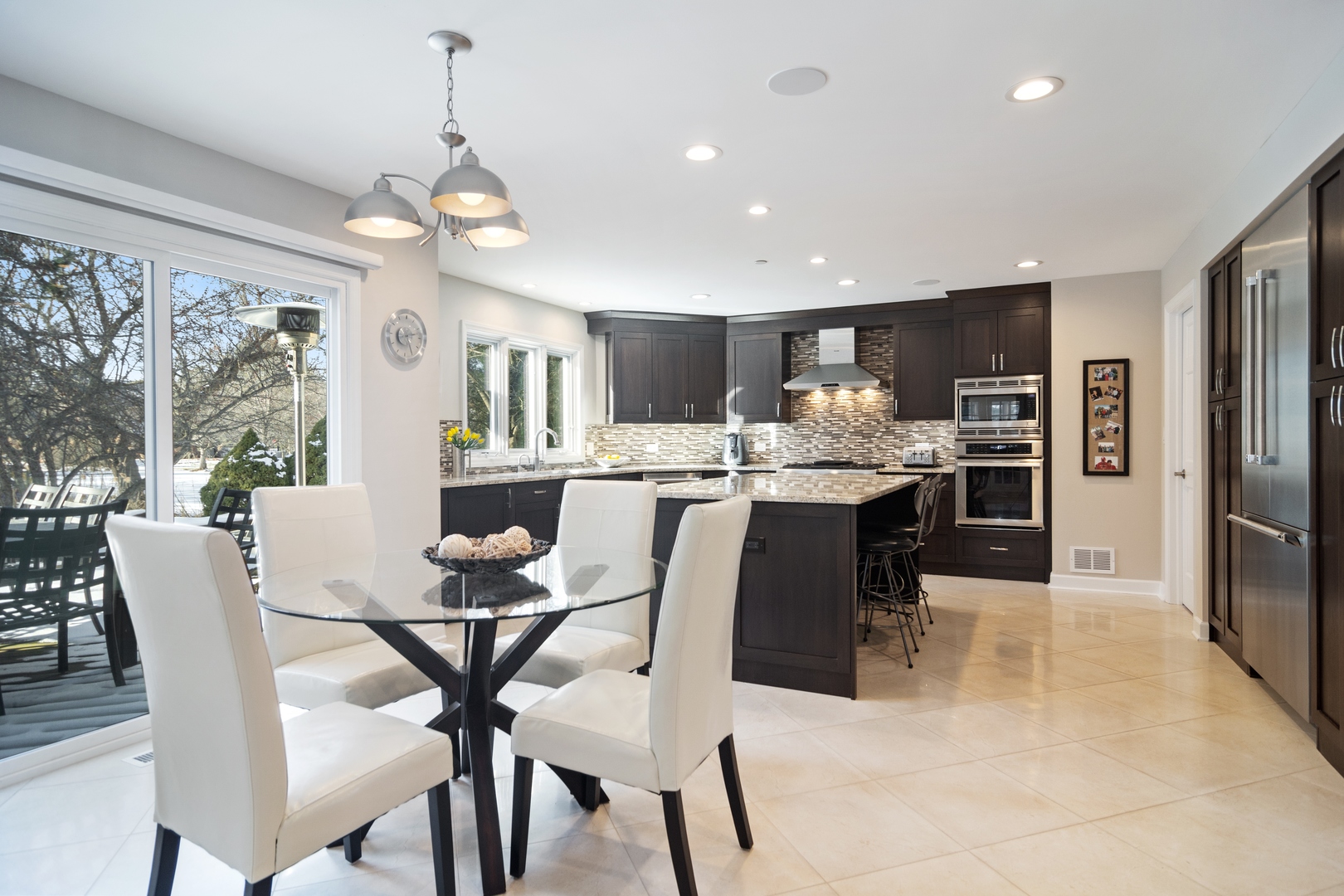 6238 Pine Tree Drive Long Grove, IL 60047 - Photo 6 of 28 a dining room filled chandelier and kitchen view
