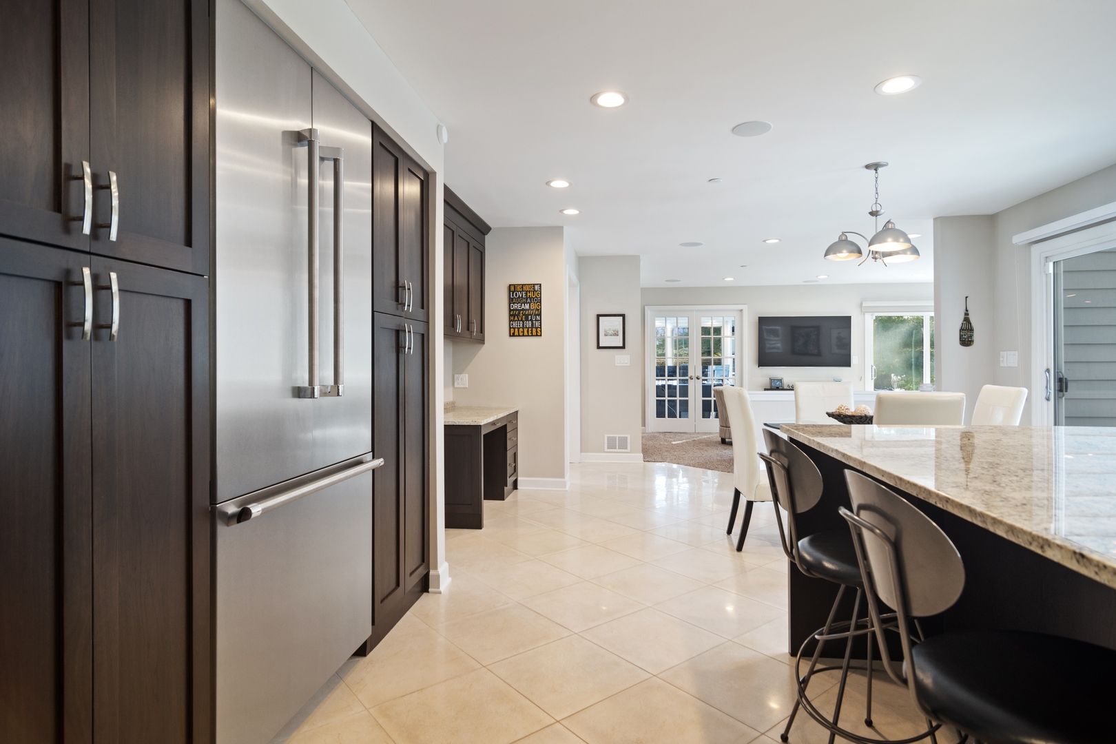6238 Pine Tree Drive Long Grove, IL 60047 - Photo 7 of 28 a kitchen with stainless steel appliances kitchen island granite countertop a refrigerator and cabinets