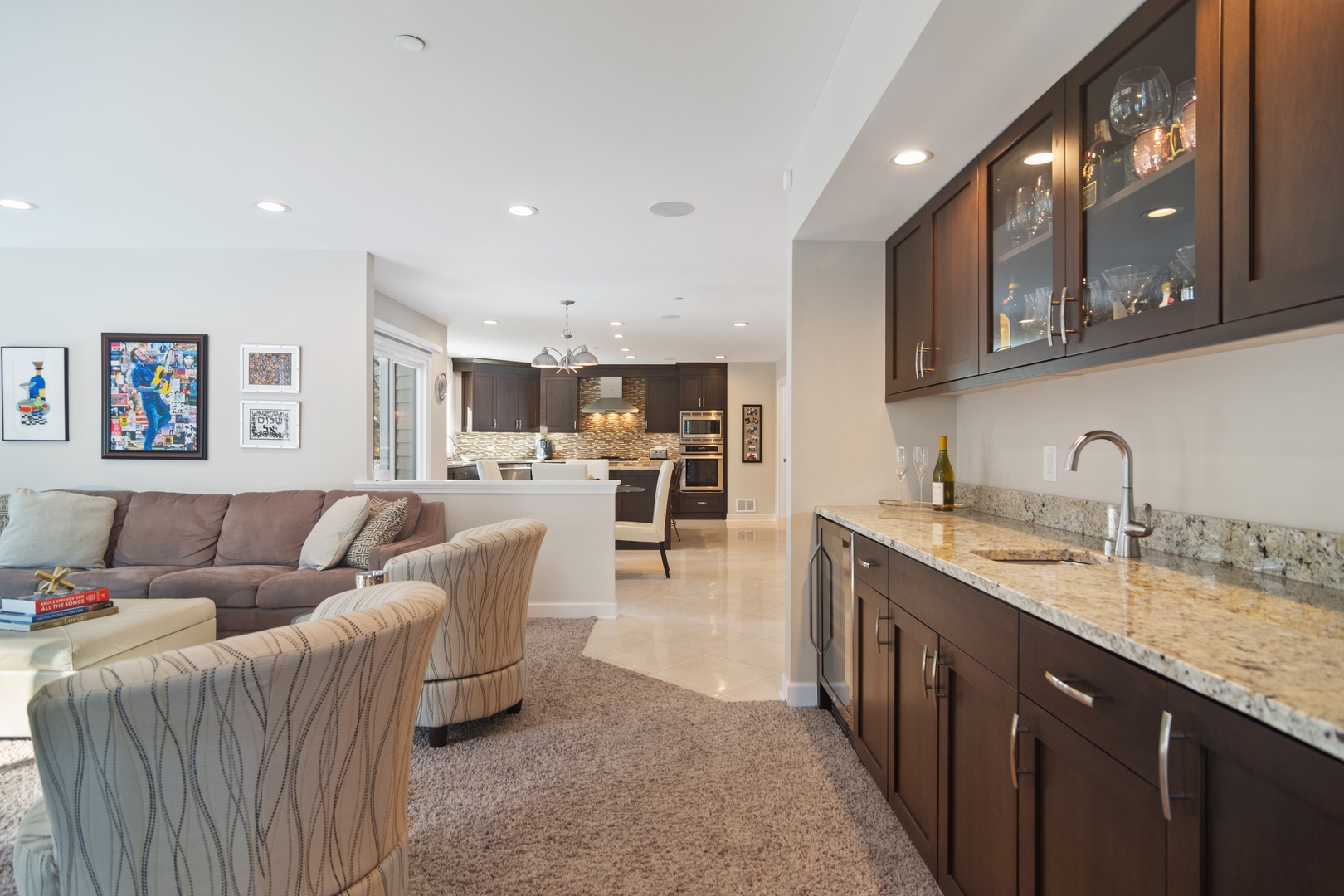 6238 Pine Tree Drive Long Grove, IL 60047 - Photo 8 of 28 a living room with stainless steel appliances kitchen island granite countertop a couch and a sink