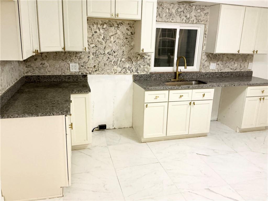 3326 Spring Garden Road Pittsburgh, PA 15212 - Photo 16 of 21 a kitchen with granite countertop a sink and a stove