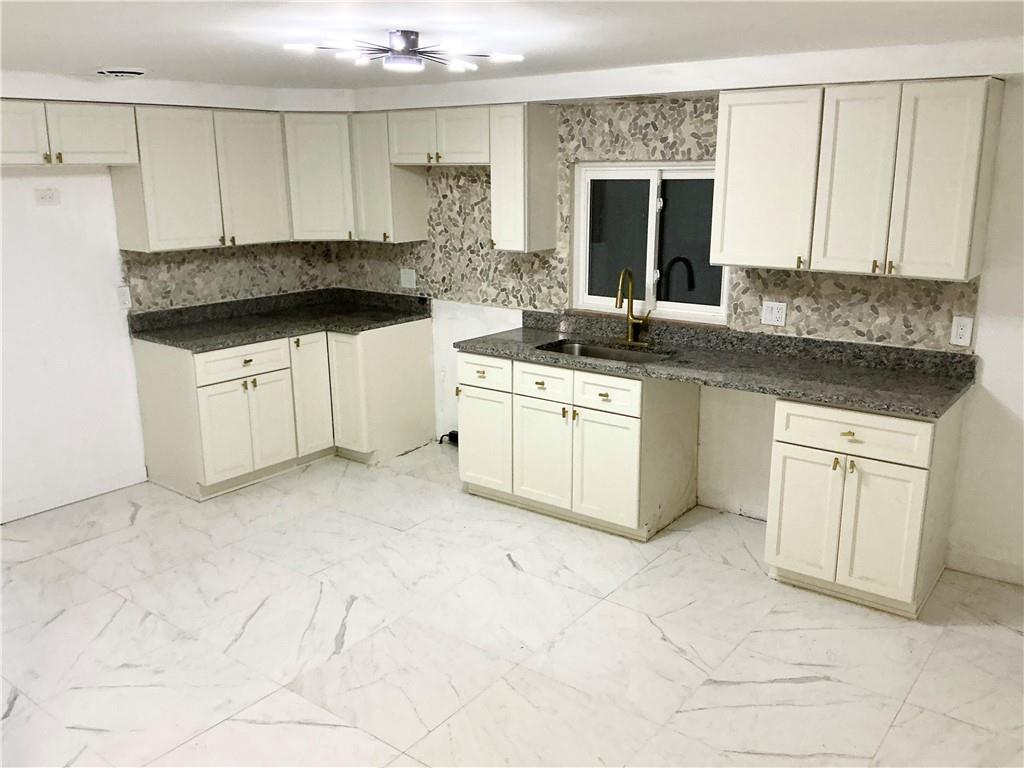 3326 Spring Garden Road Pittsburgh, PA 15212 - Photo 5 of 21 a kitchen with stainless steel appliances granite countertop a stove a sink and a white cabinets